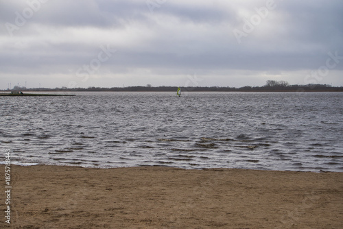 person kite surfing on a cold lake
