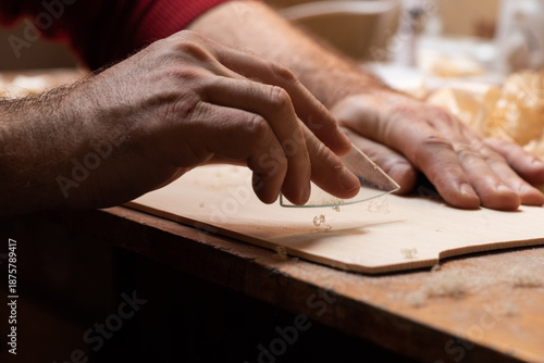The master cycles the surface of the tagelharpa soundboard with glass
