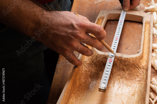The master marks the talharps on the soundboard with a pencil