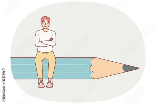 Man designer sits on giant pencil and crosses arms in front of chest, demonstrating confidence