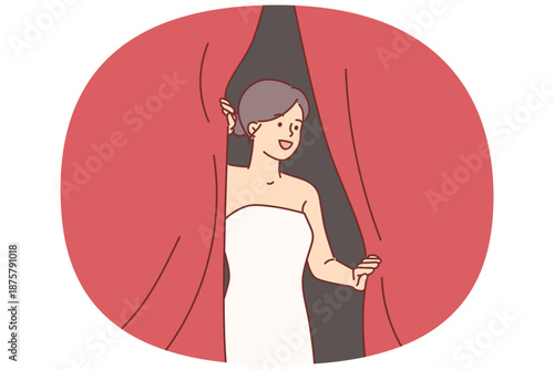 Woman superstar looks out from behind curtains of theater, waiting to go on stage