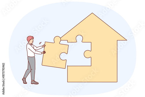 Man real estate agent is building house from puzzles, creating own apartment sales agency.