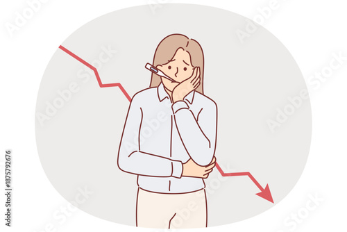 Woman entrepreneur is experiencing problems in business, standing near falling chart