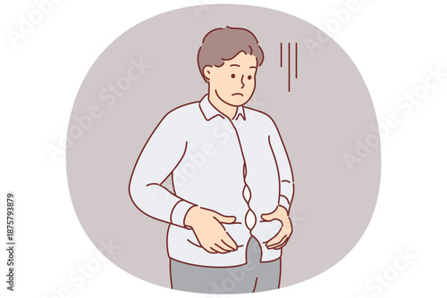 Overweight man is upset holding stomach, dressed in small shirt and needs to consult nutritionist
