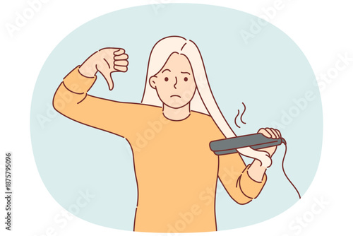 Woman using hair straightener shows thumbs down giving negative feedback about hairstyle care device