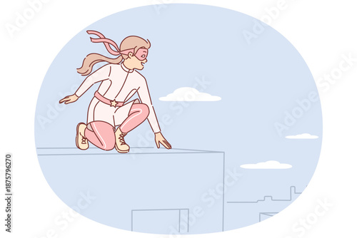 Little girl plays superhero sitting on roof and dreams of saving city residents from attackers