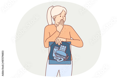 Junk food in stomach of woman holding x-ray and fearfully covering mouth with hand
