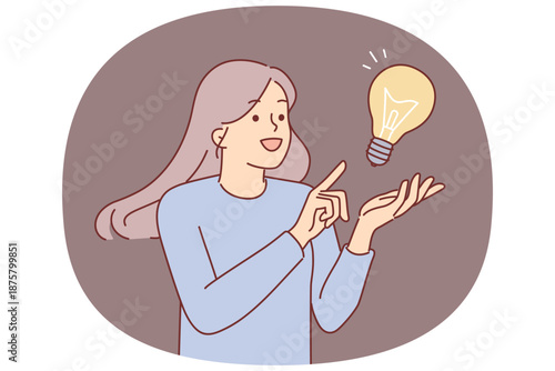 Inspired woman comes up with idea to save energy resources, stands near giant lamp