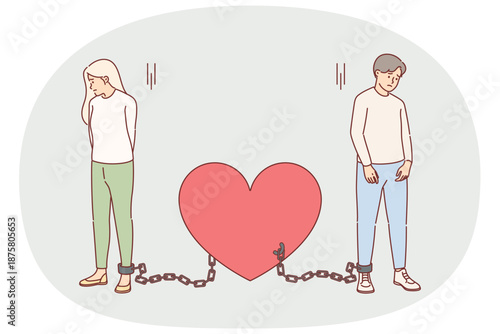Shackled couple in love suffers from lack personal freedom, stands tied with chains to heart