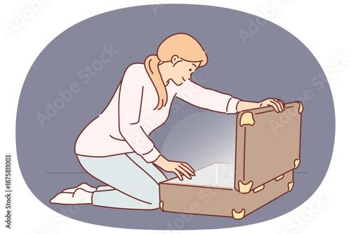 Woman opens large suitcase and sees glow, for concept of discovering treasure with valuables