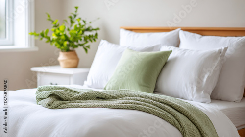 Fresh spring bedroom with white linen and green accents for a bright and relaxing atmosphere