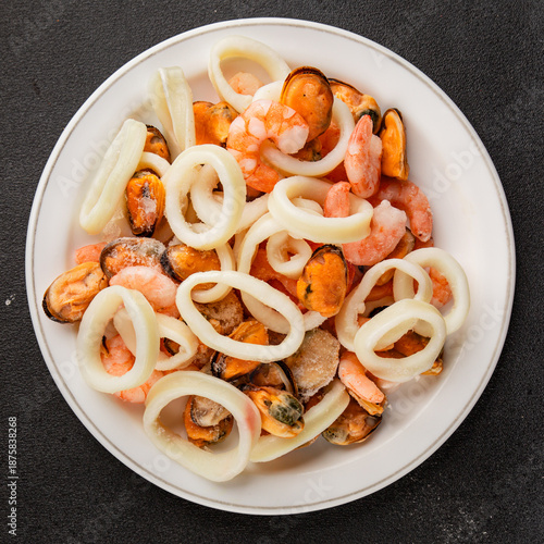 Raw seafood mix shrimp, scallops, mussels, prawns tasty snack fresh delicious gourmet food background on the table rustic food top view copy space pescetarian diet