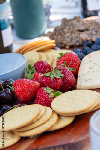 cheese and fruit platter on wooden board