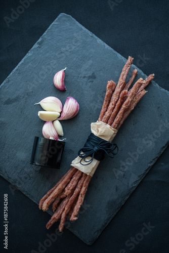 A bunch of cabanos lying among the garlic