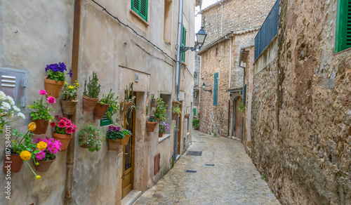 Travel Beautiful street in Valldemossa with traditional flower decoration, famous old mediterranean village of Majorca. Balearic island Mallorca, Spain