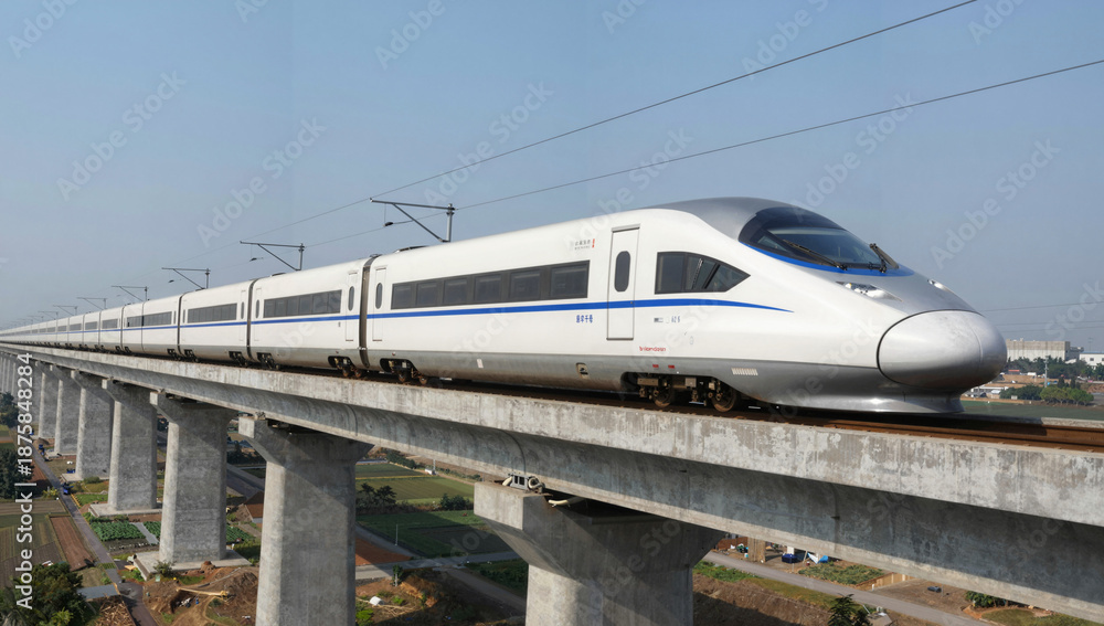 Fototapeta premium Cinematic high-speed train on a concrete viaduct slicing through a rural landscape under a clear blue sky