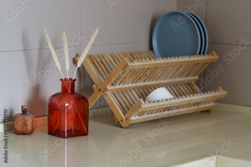 Amber glass vase with dried wheat on kitchen counter
