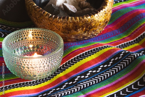 Vászonkép Spiritual ceremony altar with burning candle and healing stones on vibrant color