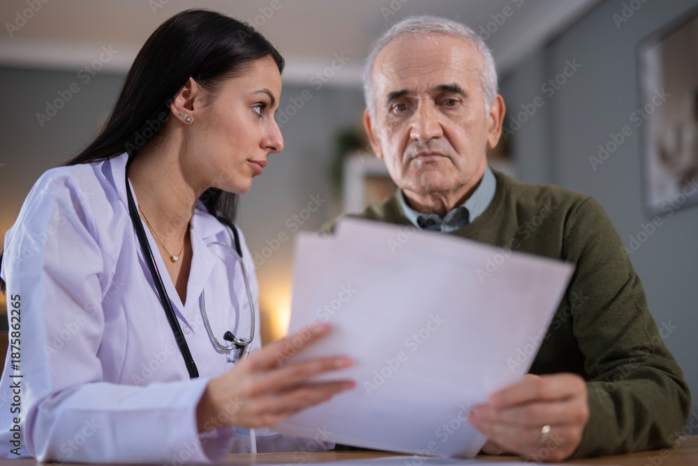 Fototapeta premium Doctor discussing medical test results with senior patient
