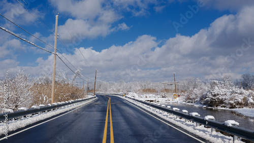 Local road through south New Jersey covered with black ice after a early season snow storm