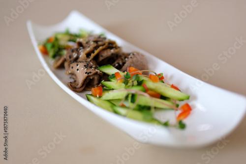 Two plates with traditional Thai beef salad with vegetables and mint top view served on rustic concrete background, healthy exotic asian meal. High quality photo