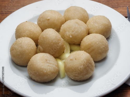 Serving or round traditional Polish dumplings on a white plate. Tasty simple food. Healthy meal portion.
