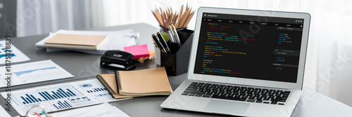 Data analysis dashboard display on laptop screen on office table with financial papers by Fintech BI technology for business marketing and strategy in corporate meeting room. Insight © InfiniteFlow