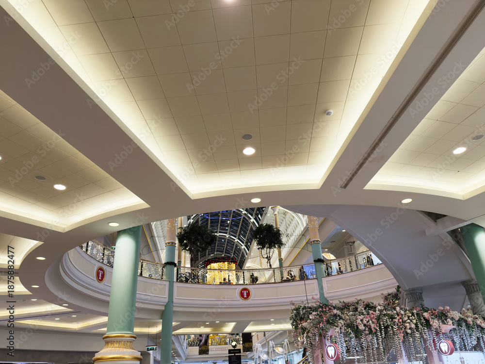 Fototapeta premium Bright interior Trafford Centre mall atrium in Manchester with festive decorations, shoppers and elegant arches