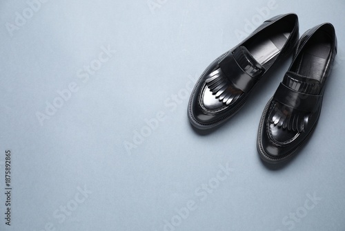 Photos Pair of stylish black loafer shoes on grey background, flat lay