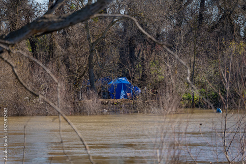 Bild auf Leinwand homeless encampment along the wooded banks of the Sacramento River