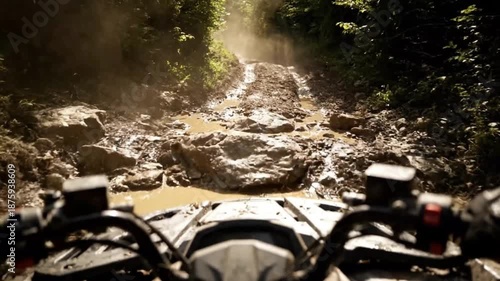 Riding through a rugged muddy trail surrounded by dense foliage on a motorbike
