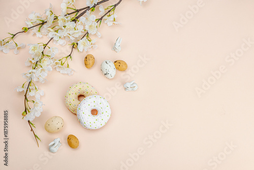 Handmade crocheted donuts with blooming cherry branches. Festive Easter, greeting card