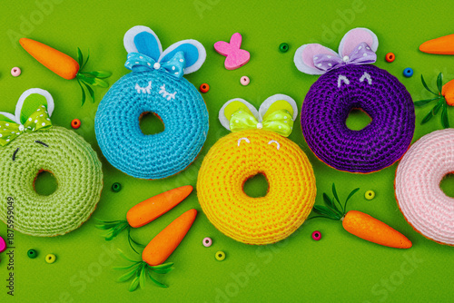 Handmade Easter concept. Crocheted donuts bunnies with traditional decoration. Festive symbols