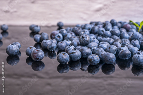 Tablou pe pânză A solitary blueberry, split in half, reveals its surprising pale green interior