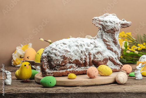 Easter lamb cake with traditional spring decor. Baked sweet dessert with icing. Festive background