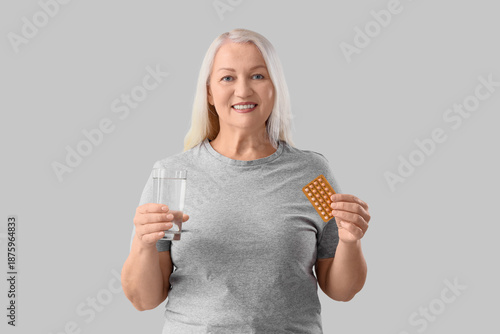 Mature woman with glass of ...