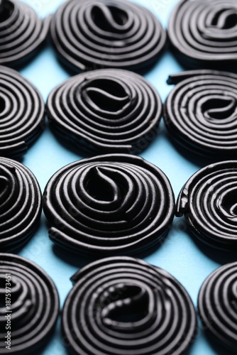 Natural licorice candies on light blue background, closeup