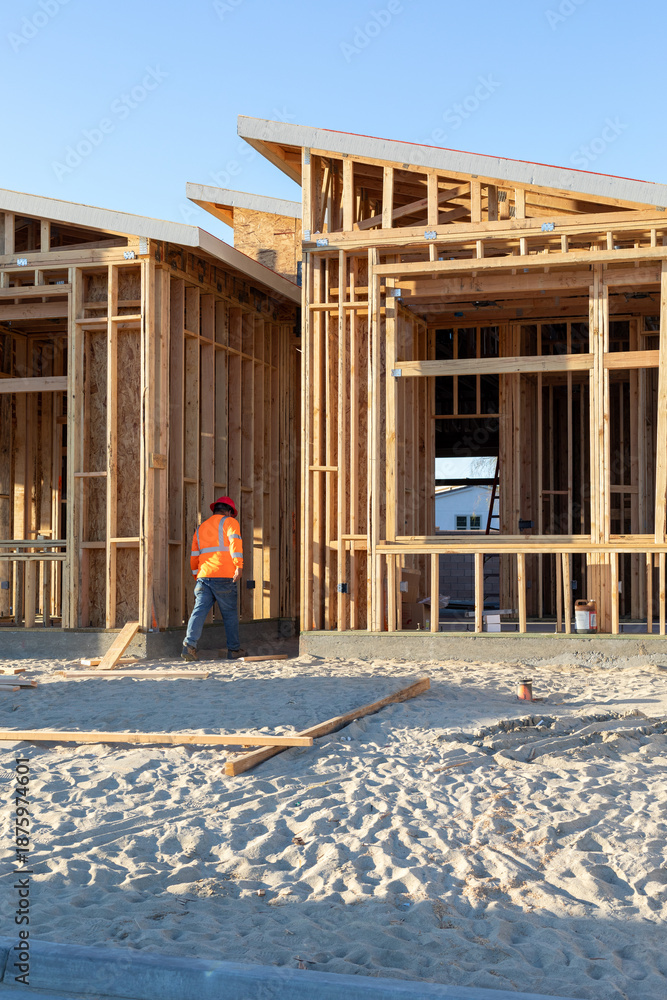 Fototapeta premium Modern wood frame construction and a construction worker