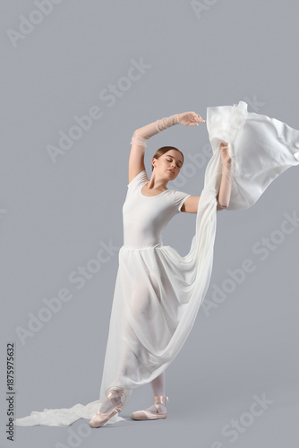 Young ballerina on light ba...