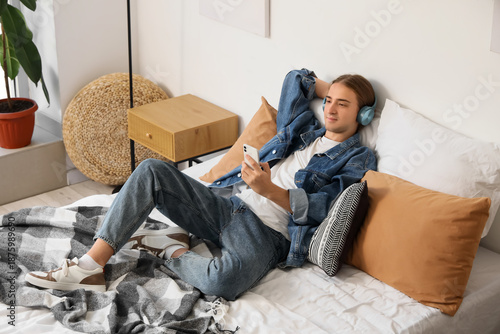 Young man with headphones u...