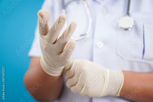 Medical Staff Putting On Protective Gloves Before Clinical Work
