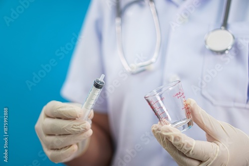 Medical Staff Preparing Equipment for Solution Transfer