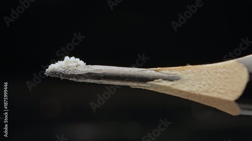 Lethal dose of fentanyl on the tip of a pencil. Two milligrams of fentanyl is lethal dose for humans. Synthetic narcotic analgesic drug. Tiny pile of powder on a pencil tip to give a sense of scale.