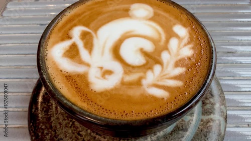 Froth art in a cup of magic coffee