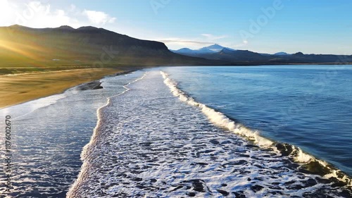Cinematic Sunrise over Black Sand Volcanic Beach with Crashing Waves, Serene and Tranquil Landscape. Iceland.