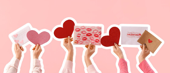 Female hands with hearts and letters on pink background. Valentine's Day celebration