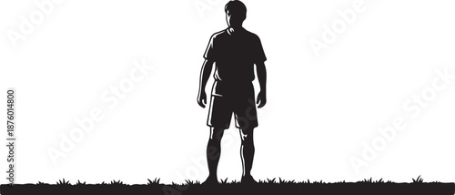 Silhouette of a man standing on grassy field alone