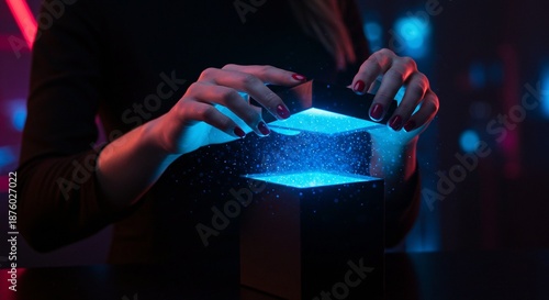 A person opens a mysterious box emitting a bright blue light, creating an aura of intrigue and magic.