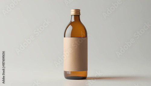 Brown glass bottle with blank label on white background