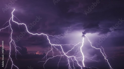 Multiple bright lightning strikes illuminate dark, purple storm clouds over the horizon